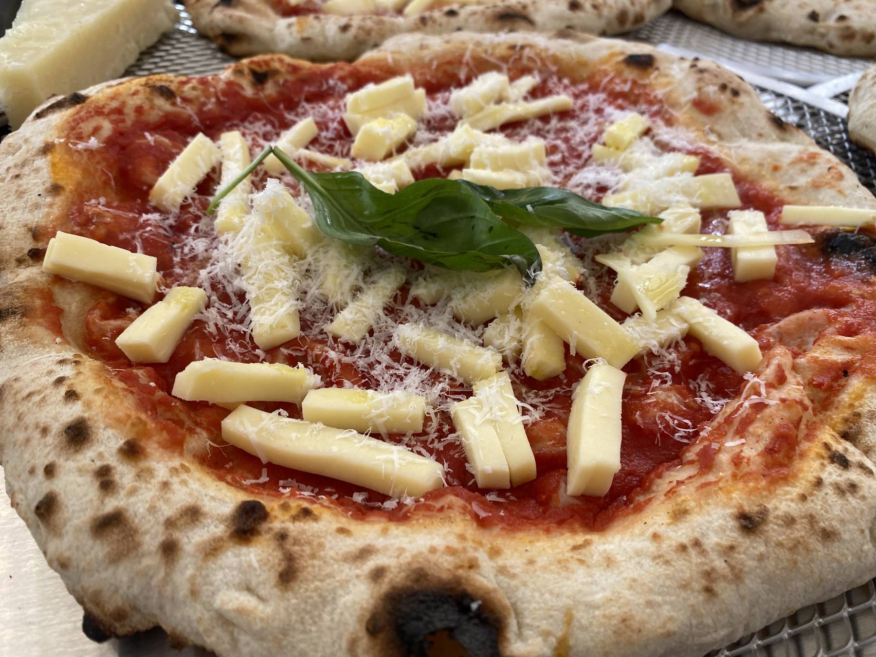 Close-up of a Home Slice pizza with mozzarella and basil